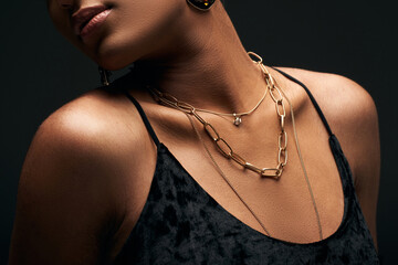 Cropped view of fashionable african american woman in evening dress and with golden necklaces...