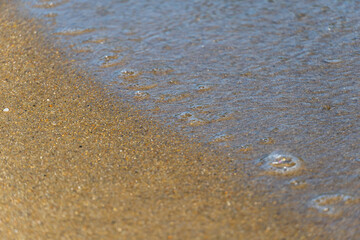 Sand and sea water on the beach in Angra do Reis, in Rio de Janeiro. Sunny day in the morning. Close-up