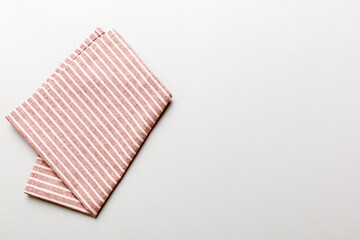 top view with red empty kitchen napkin isolated on table background. Folded cloth for mockup with copy space, Flat lay. Minimal style