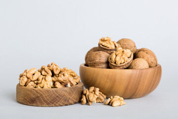 Fresh healthy walnuts in bowl on colored table background. Top view Healthy eating bertholletia concept. Super foods