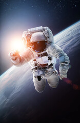 Astronaut in outer space over the planet Earth. Spaceman spacewalk. Orbit of Earth in deep space....