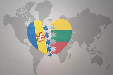 puzzle heart with the national flag of lithuania and madeira on a world map background. Concept.