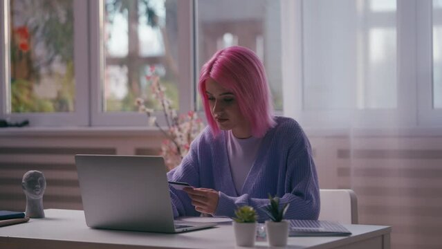Woman having problems with credit card payment on laptop, stolen credentials