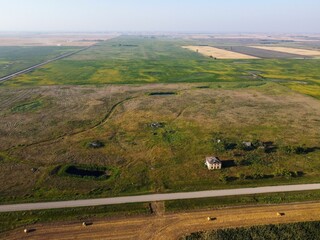 Fototapeta premium Bird's eye view of an abandoned farmhouse in the prairies of Saskatchewan, Canada