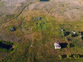 Bird's eye view of an abandoned farmhouse in the prairies of Saskatchewan, Canada