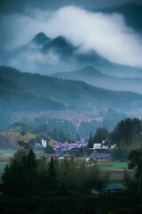 Fototapeta na wymiar Mountain village on a foggy day