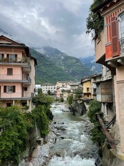 Fototapeta na wymiar Vertical shot of a streaming river through the Chiavenna