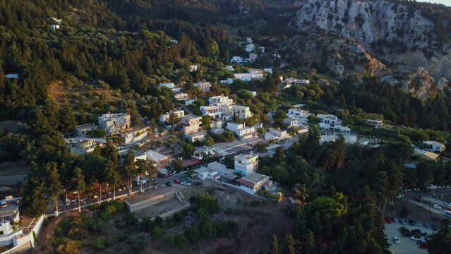 Village Zia on the island of Kos, Greece, surrounded by trees, with a mountain in the background