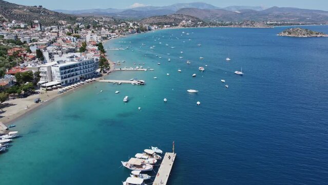Bird's eye view of small town of Tolo in Argolida, Greece against blue sea on a sunny day