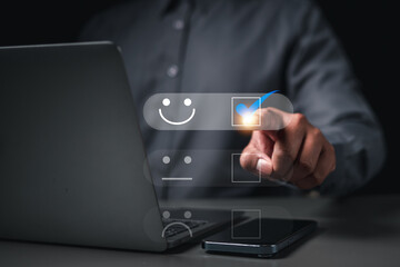 Businessman pressing smiley face emoticon on touch screen.