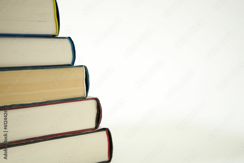 Poster closeup of a stack of books isolated on a white background with copyspace