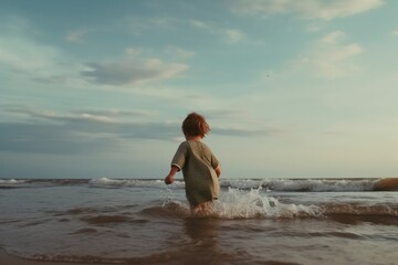 Fototapeta premium Happy child running in the waves during summer vacation on exotic tropical beach. Holiday on ocean coast for family with young children. Kids play at the sea Generative AI