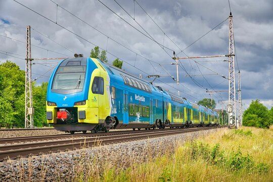 Stadler KISS electric train driving over the railway tracks in Dedensen Guemmer, Germany