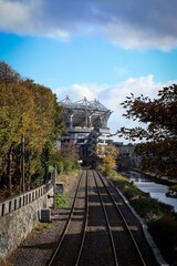 Vertical shot of the railway track surrounded by trees and lake