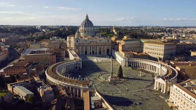 Aerial footage of Vatican Square and surrounding buildings under blue sky
