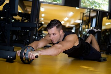 Muscular Caucasian man doing exercises in gym