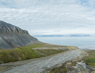 Fototapeta na wymiar Beautiful shot of a landscape with mountains during the day in Svalbard, Norway