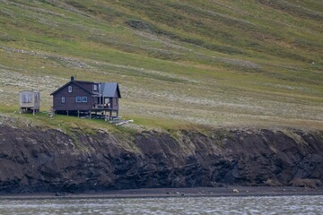 Fototapeta na wymiar Small house on the coast in Svalbard, Norway