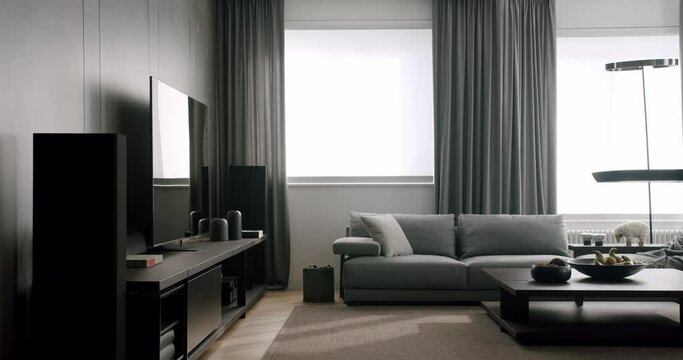 Contemporary interior design of the living room with TV chest of drawers. Modern interior living room with simple commode. Luxury Elegant Room. Minimalist Home Interior. Cozy Modern Furniture Design.