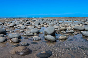Large bolders on the beach at low tide in North Devon