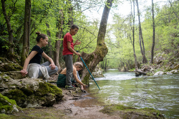 group of children crossing a mountain river