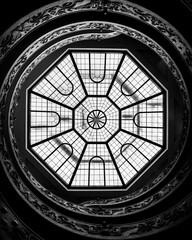 Grayscale low angle shot of the Bramante Staircase ceiling (Scala Elicoidale Momo) in Vatican City