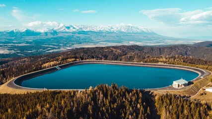 Aerial shot of Pumped Storage Power Plant Cierny Vah, High Tatras mountains in the background