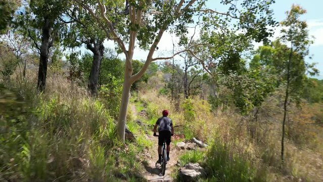 High angle of person riding a bicycle through Pallarenda mountain trail in Townsville, Queensland