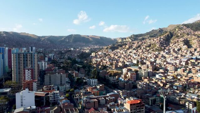 4k aerial footage of La Paz city, houses in Bolivia with mountains and cloudy sky on a sunny day