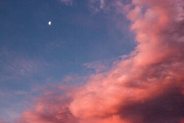 Fototapeta na wymiar Pink clouds with the moon in the sky