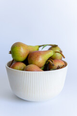 pears in a plate on a white background close-up with a blurred background.