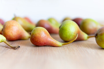 pear on a wooden table close-up in the foreground with a blurred background.