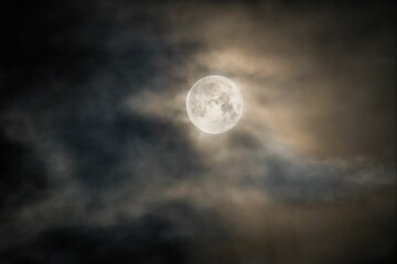Naklejka na ściany i meble Night sky with the moon behind the clouds