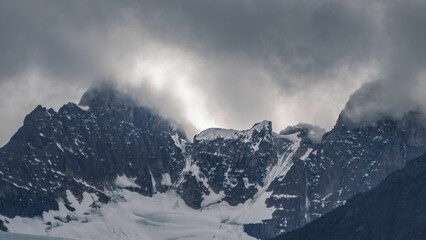 Fototapeta na wymiar Snowy peak with stormy cloudy sky in Mistaya Canyon, Banff town, Canada