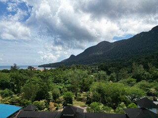 Aerial view of the ocean surrounded by beautiful greenery and resorts in Sarawak