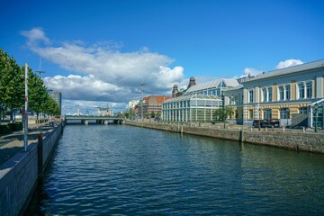 Naklejka premium Canal with buildings and a bridge in the background in Malmo, Sweden