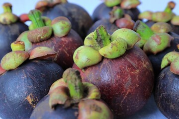 Closeup of mangosteen fruit seeds on a white surface