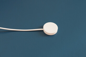  Wireless charger for smartwatches on blue background.
