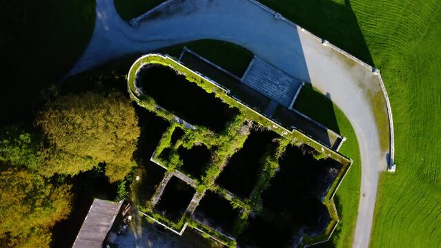 High-angle shot of an old castle in the green park and valley in Limerick, Ireland.