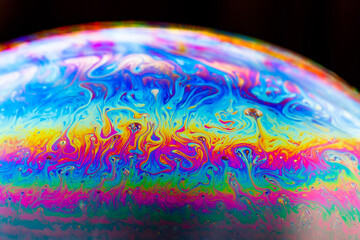 Vibrant Macro of a Soap Bubble Surface with Iridescent Rainbow Patterns and Abstract Swirling...