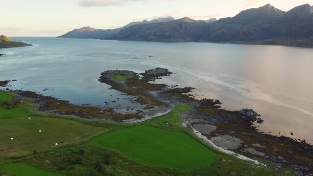 Aerial footage of a river and mountains in the Lofoten Islands in Norway