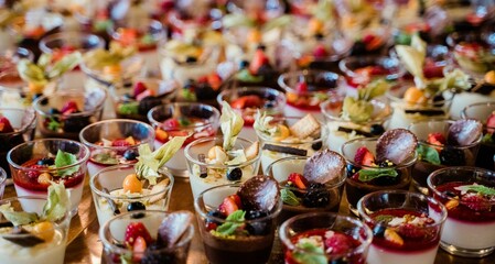 Fototapeta na wymiar Closeup of delicious desserts in glasses on a wedding day