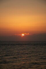Naklejka na ściany i meble Vertical shot of a beautiful sunset over the Adriatic sea on an Italian shore