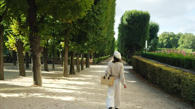 Attractive girl walking in the garden in Paris