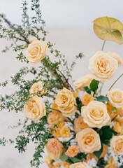 Obraz na płótnie Canvas Vertical shot of soft orange wedding roses