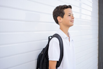 Charming caucasian teenager with backpack outdoors