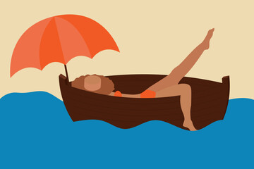 A girl in a bathing suit and a hat is resting in a boat under an umbrella. Splashing foot in the water and enjoying vacation