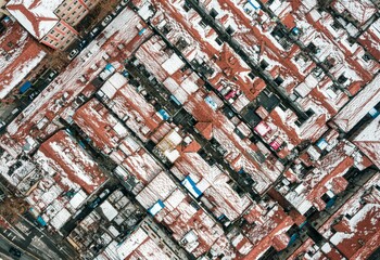 Birds eye view of snow-covered roofs of houses in Kunhouli Community