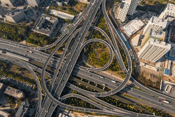 Fototapeta premium Aerial drone view of a traffic on a road junction in Wuhan on a sunny day