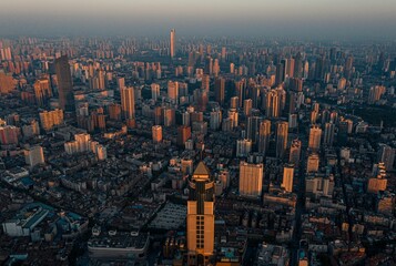 Cityscape of Wuhan city skyscrapers with foggy sky at sunset in China